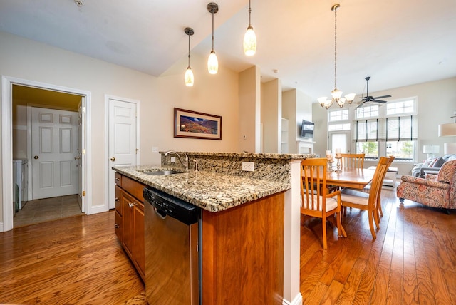 45 Grey Hawk Dr Unit 578, Mashpee, MA 02649 - kitchen with open floor plan, a chandelier, stainless steel dishwasher, brown cabinets, and wood finished floors