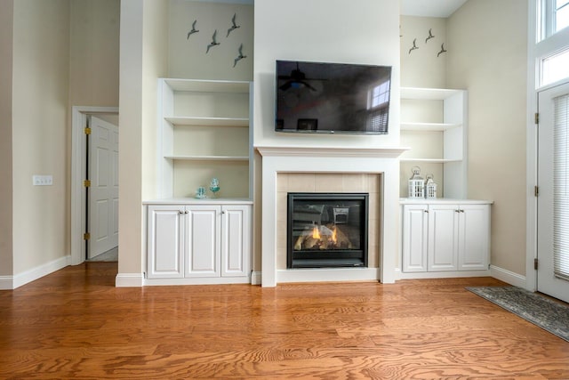 45 Grey Hawk Dr Unit 578, Mashpee, MA 02649 - unfurnished living room featuring baseboards, built in features, wood finished floors, and a tile fireplace