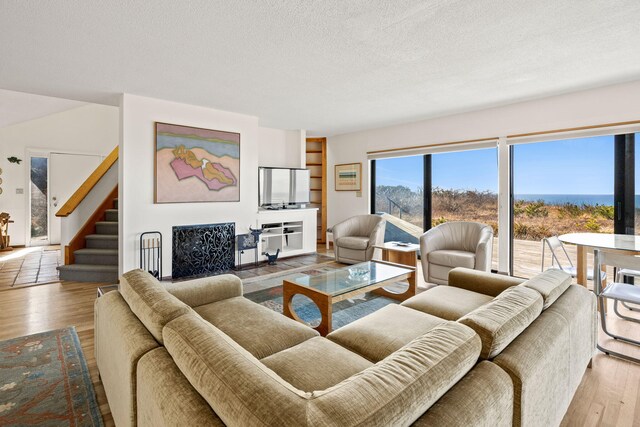 47 Fishermans Rd, Truro, MA 02666 - living area featuring wood finished floors, stairs, and a textured ceiling