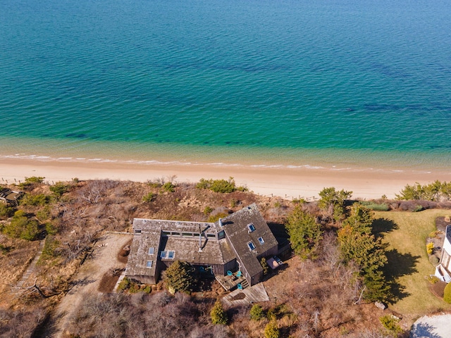 bird's eye view featuring a water view and a beach view