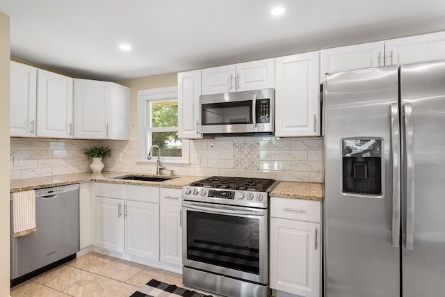 20 Terry Ln E, Wareham, MA 02571 - kitchen featuring appliances with stainless steel finishes, white cabinets, backsplash, light stone counters, and recessed lighting