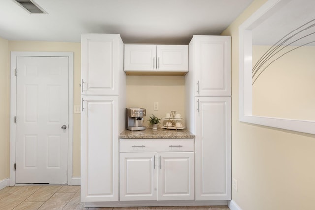 20 Terry Ln E, Wareham, MA 02571 - kitchen featuring white cabinetry, light stone counters, and light tile patterned flooring
