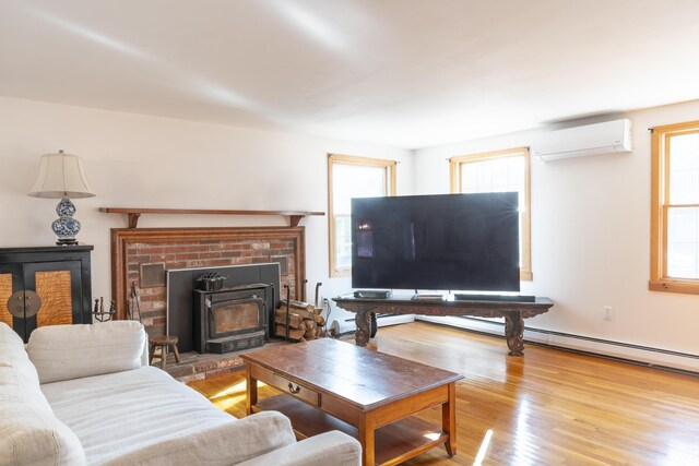 living room featuring light hardwood / wood-style floors and a wall unit AC