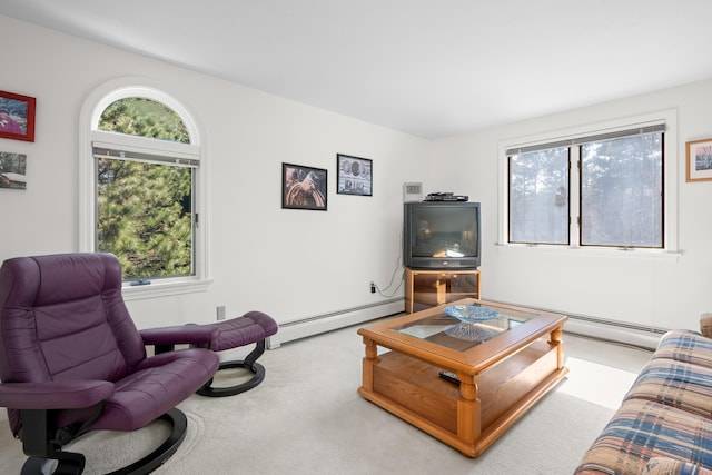 carpeted living area featuring baseboard heating and a wealth of natural light
