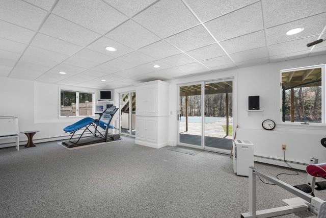 workout room with a baseboard radiator, recessed lighting, a drop ceiling, and plenty of natural light