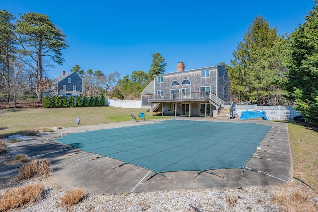 rear view of house with a yard, stairway, fence, and a deck