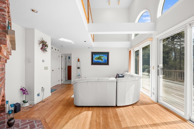 living area featuring baseboards and light wood-style flooring