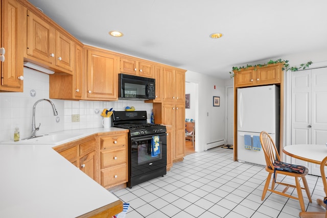 kitchen featuring light countertops, a sink, black appliances, and tasteful backsplash