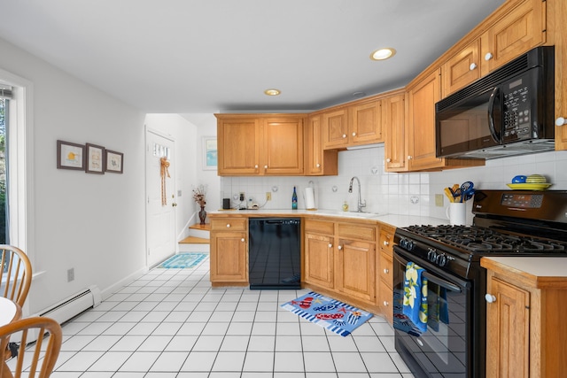kitchen featuring light countertops, decorative backsplash, a sink, and black appliances