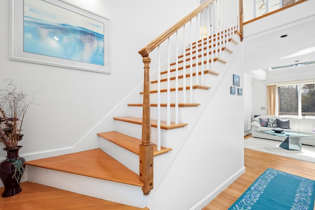 stairs with baseboards and wood finished floors