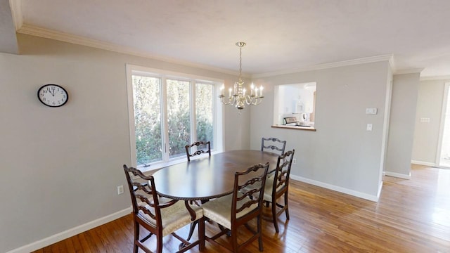 23 W Woods Vlg, Yarmouth Port, MA 02675 - dining area featuring light wood-type flooring, a chandelier, and ornamental molding