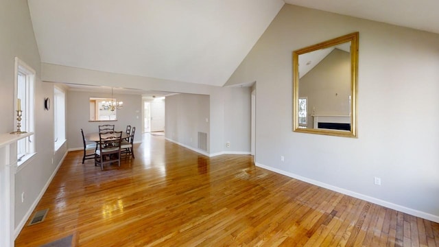23 W Woods Vlg, Yarmouth Port, MA 02675 - dining area with a chandelier, light wood finished floors, and high vaulted ceiling