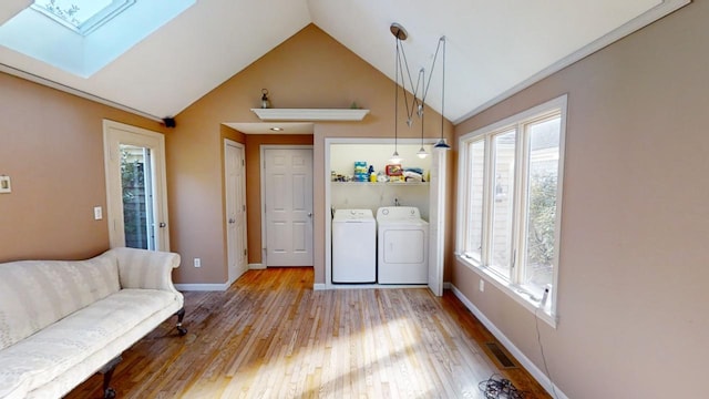 23 W Woods Vlg, Yarmouth Port, MA 02675 - laundry area featuring a skylight, separate washer and dryer, healthy amount of natural light, and light wood-style flooring