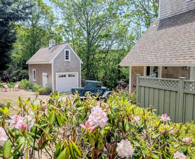 41 Halyard Ln, Mashpee, MA 02649 - view of yard with a detached garage, an outdoor structure, and view of wooded area