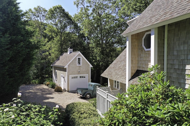 41 Halyard Ln, Mashpee, MA 02649 - view of side of property with an outdoor structure, a garage, and roof with shingles