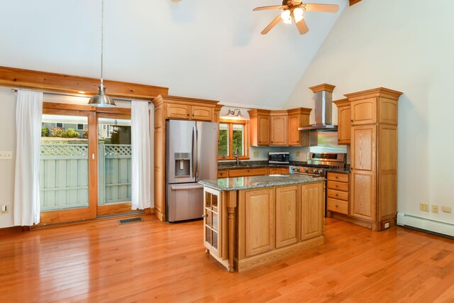 kitchen with sink, extractor fan, dark stone countertops, and appliances with stainless steel finishes