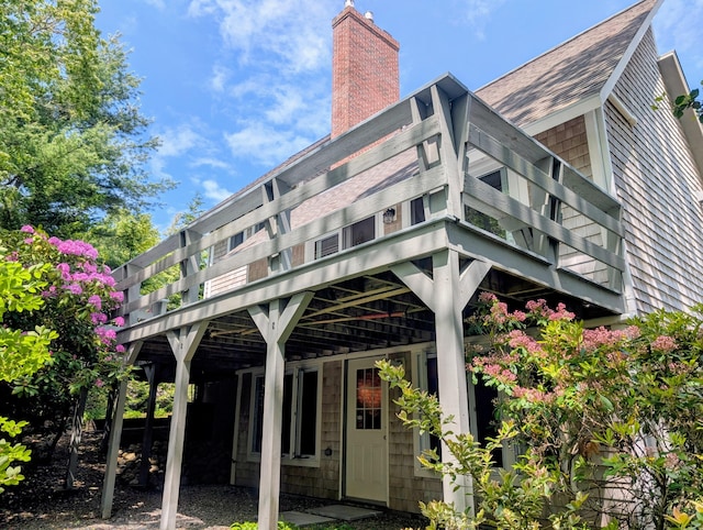 41 Halyard Ln, Mashpee, MA 02649 - back of house with a shingled roof and a chimney