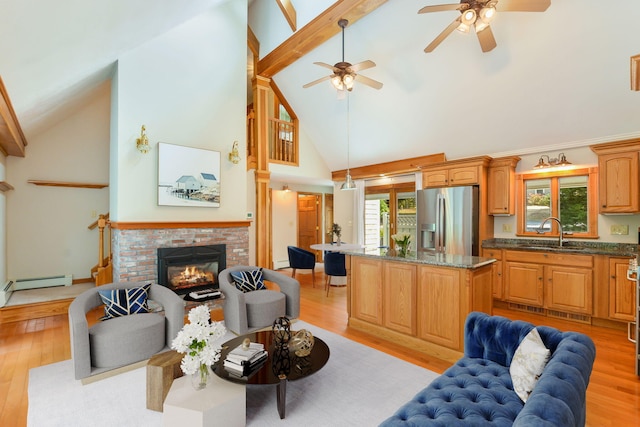 41 Halyard Ln, Mashpee, MA 02649 - living room featuring high vaulted ceiling, healthy amount of natural light, a ceiling fan, a brick fireplace, and light wood-style floors