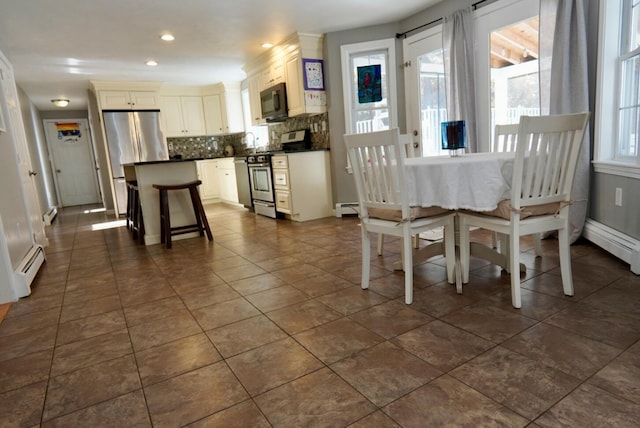 57 Camden Ln, Mashpee, MA 02649 - dining area featuring dark tile patterned floors, baseboard heating, and recessed lighting
