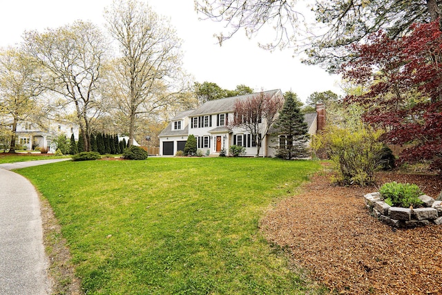 57 Camden Ln, Mashpee, MA 02649 - colonial-style house featuring a front yard and a chimney