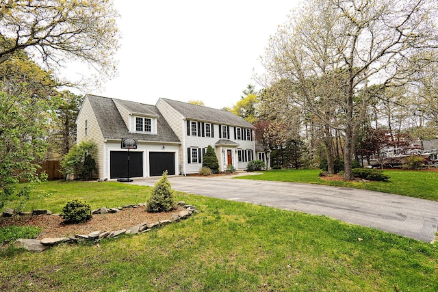 57 Camden Ln, Mashpee, MA 02649 - colonial home with asphalt driveway, an attached garage, and a shingled roof
