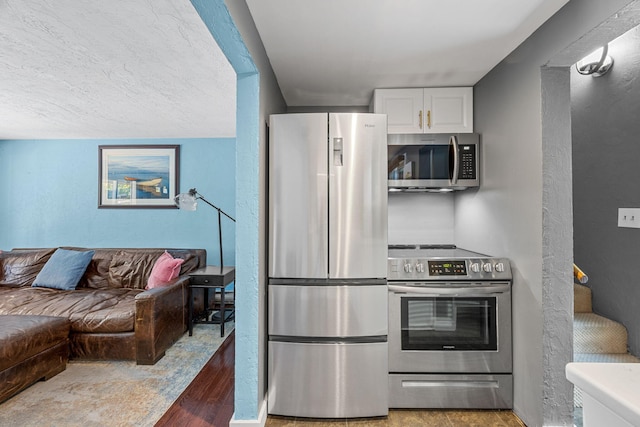 4 Bradford Acres Rd Unit F, Provincetown, MA 02657 - kitchen featuring appliances with stainless steel finishes, white cabinetry, and open floor plan