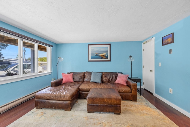 4 Bradford Acres Rd Unit F, Provincetown, MA 02657 - living area with wood finished floors, a textured ceiling, and a baseboard radiator