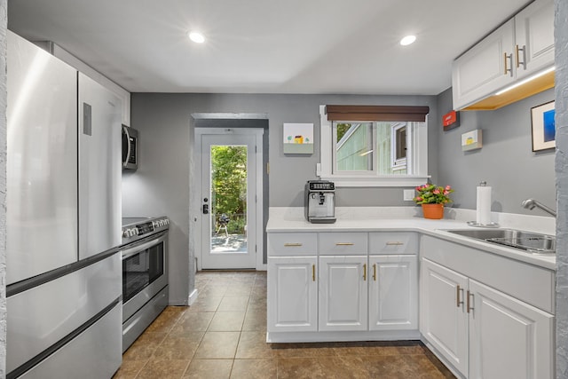 4 Bradford Acres Rd Unit F, Provincetown, MA 02657 - kitchen featuring appliances with stainless steel finishes, white cabinetry, light countertops, tile patterned flooring, and recessed lighting