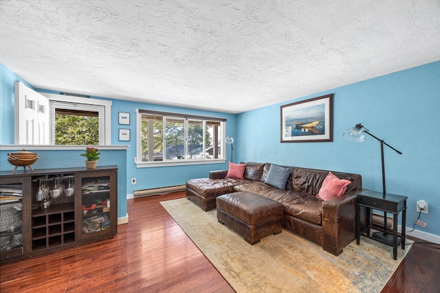 4 Bradford Acres Rd Unit F, Provincetown, MA 02657 - living area featuring a baseboard heating unit, wood-type flooring, and a textured ceiling
