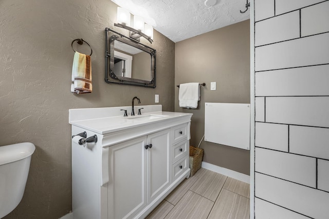 4 Bradford Acres Rd Unit F, Provincetown, MA 02657 - half bath featuring a textured ceiling, vanity, and a textured wall