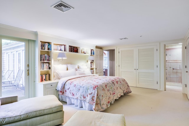 bedroom featuring light carpet, connected bathroom, and ornamental molding