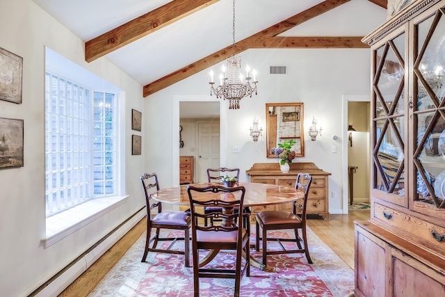 dining space with a baseboard heating unit, a chandelier, light wood-style floors, and baseboards