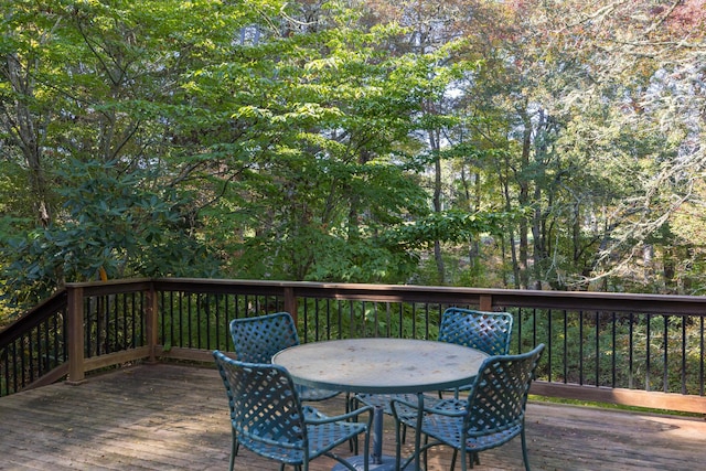 wooden terrace featuring outdoor dining area