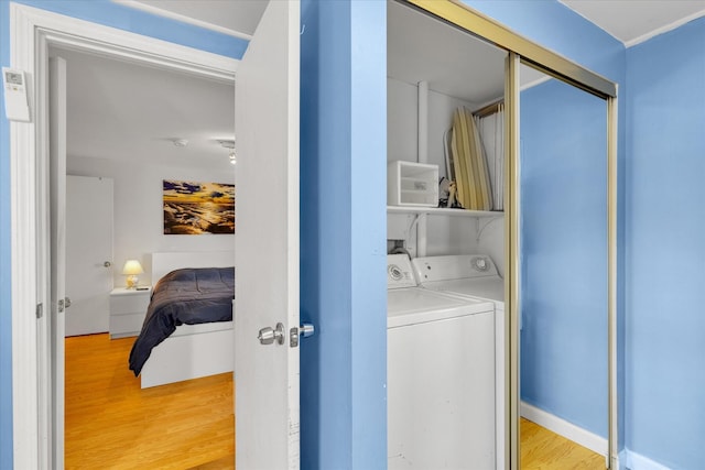 188 Captain Chase Rd, Dennis Port, MA 02639 - clothes washing area with baseboards, light wood-style floors, independent washer and dryer, and laundry area