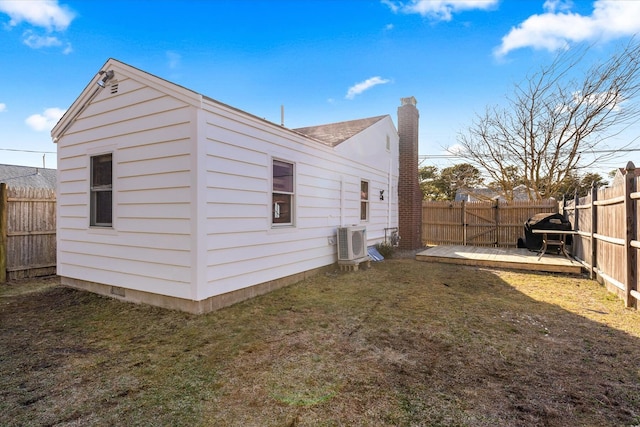 188 Captain Chase Rd, Dennis Port, MA 02639 - back of house with ac unit, a chimney, a fenced backyard, and a lawn
