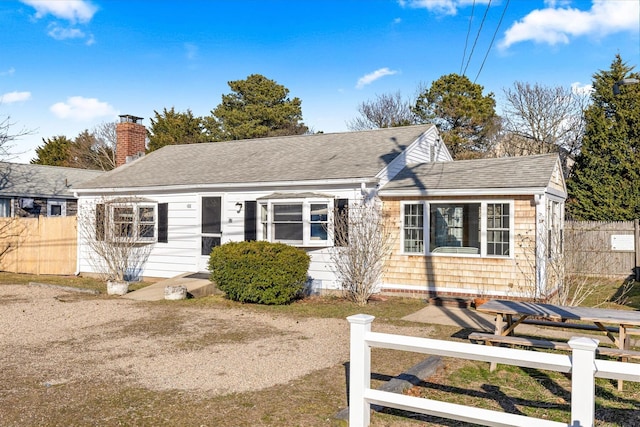 188 Captain Chase Rd, Dennis Port, MA 02639 - view of front of house with roof with shingles, a chimney, and a fenced front yard