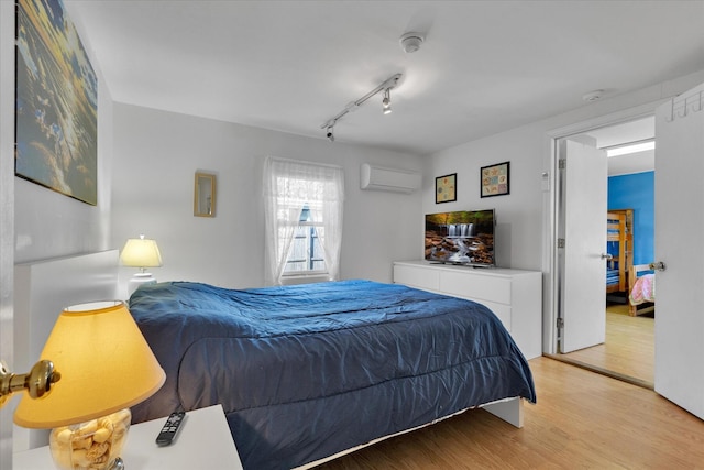 188 Captain Chase Rd, Dennis Port, MA 02639 - bedroom featuring track lighting, a wall mounted AC, and wood finished floors