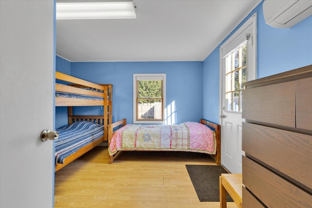 188 Captain Chase Rd, Dennis Port, MA 02639 - bedroom with multiple windows, a wall unit AC, and wood finished floors