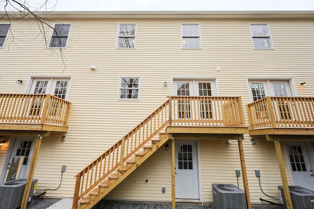 rear view of house featuring stairs and central AC unit