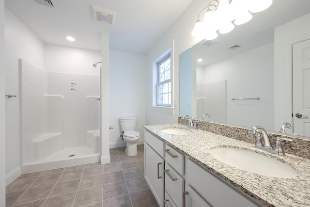 bathroom featuring toilet, tile patterned flooring, a sink, and visible vents