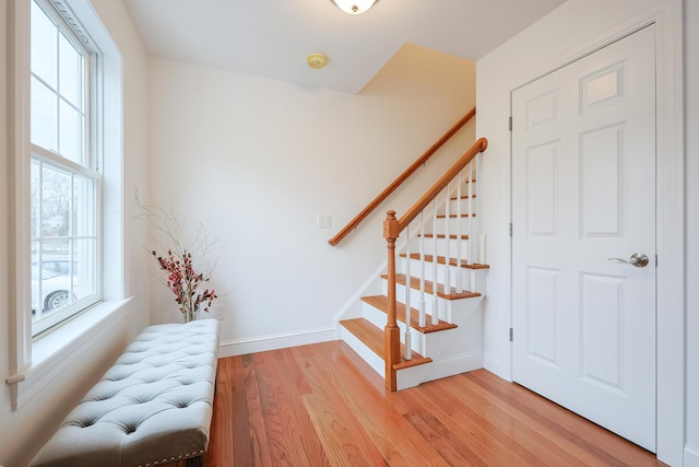 stairway with baseboards and wood finished floors