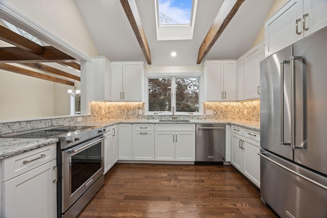 507 S Orleans Rd, Orleans, MA 02653 - kitchen with high end appliances, a sink, backsplash, white cabinets, and recessed lighting