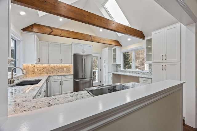 507 S Orleans Rd, Orleans, MA 02653 - kitchen featuring appliances with stainless steel finishes, a sink, recessed lighting, tasteful backsplash, and a skylight