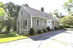 507 S Orleans Rd, Orleans, MA 02653 - view of front facade featuring a chimney and concrete driveway
