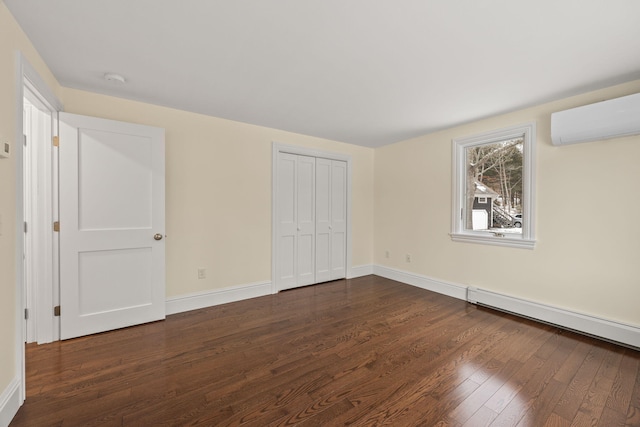 507 S Orleans Rd, Orleans, MA 02653 - unfurnished bedroom featuring an AC wall unit, dark wood-style floors, baseboards, and a closet