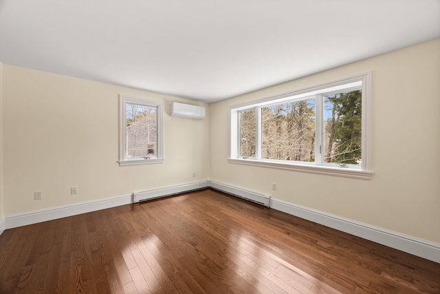 507 S Orleans Rd, Orleans, MA 02653 - spare room featuring a wall mounted AC, baseboard heating, dark wood finished floors, and baseboards