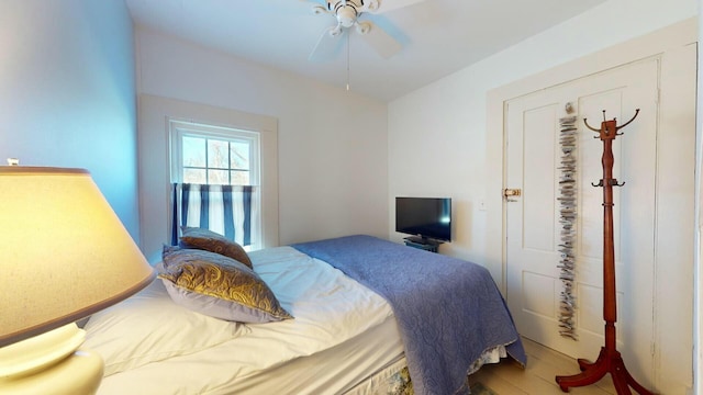 bedroom with hardwood / wood-style flooring and ceiling fan