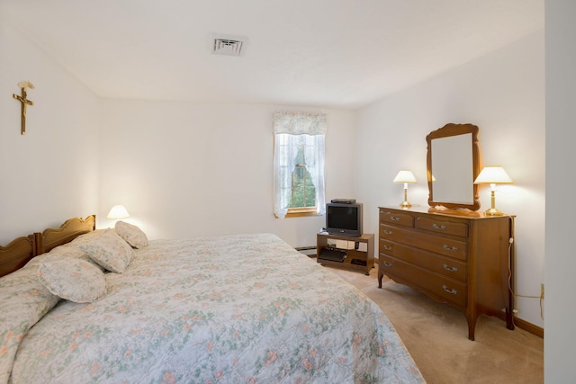 bedroom featuring light colored carpet, baseboards, and a baseboard heating unit