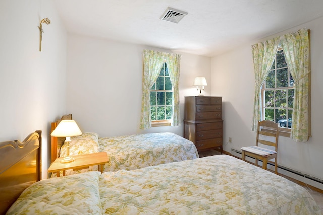 bedroom with a baseboard radiator and baseboards