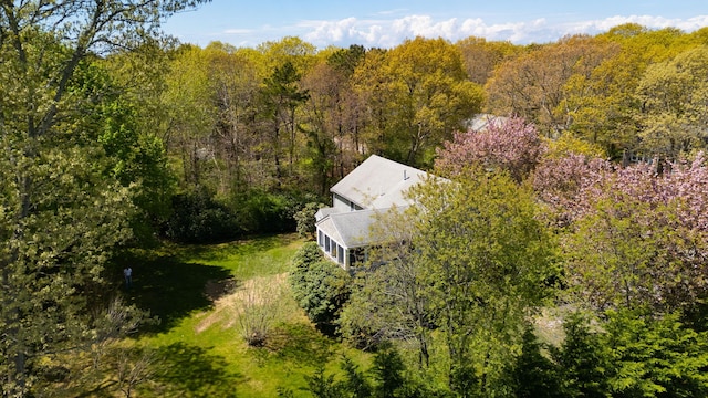 aerial view of property and surrounding area with a heavily wooded area